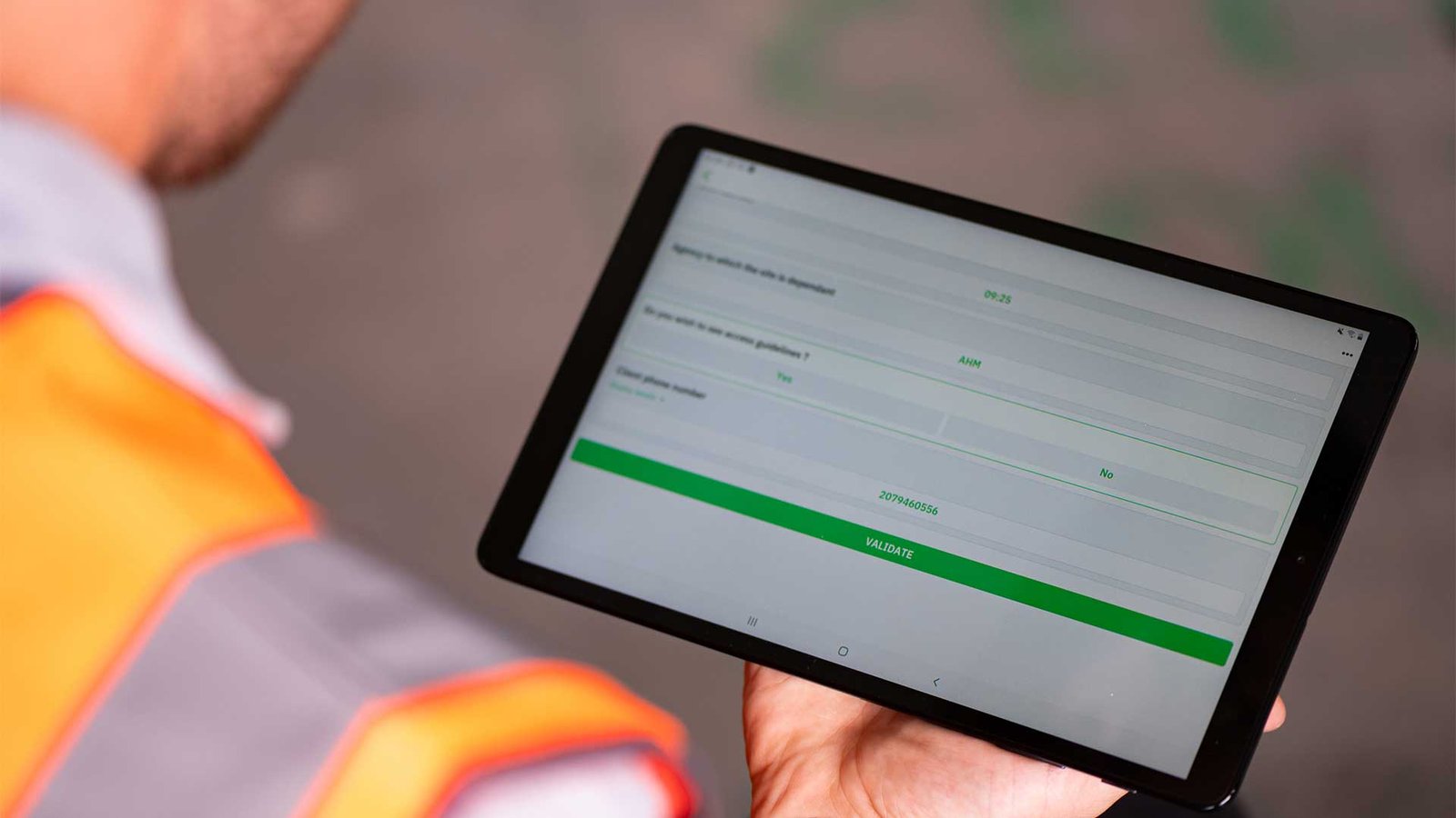 Close up image of construction workers holding tablet with Causeway Ermeo on the screen