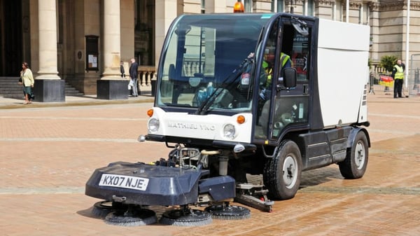 A worker on a street cleaner machine