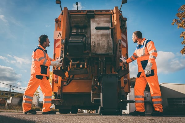 Two workers carrying out waste collection