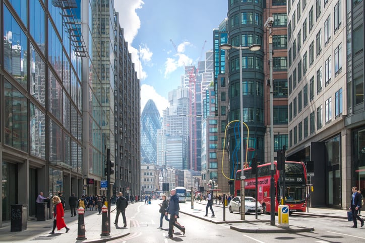 city of london busy street people crossing the road cars buildings