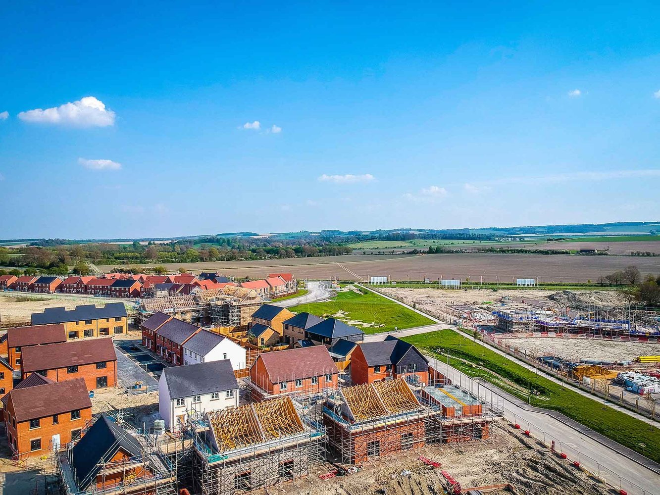 A clear blue sky stretches above a residential area